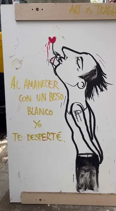 Board with a painted figure and a poetic line about dawn, Barcelona, Art Is Trash