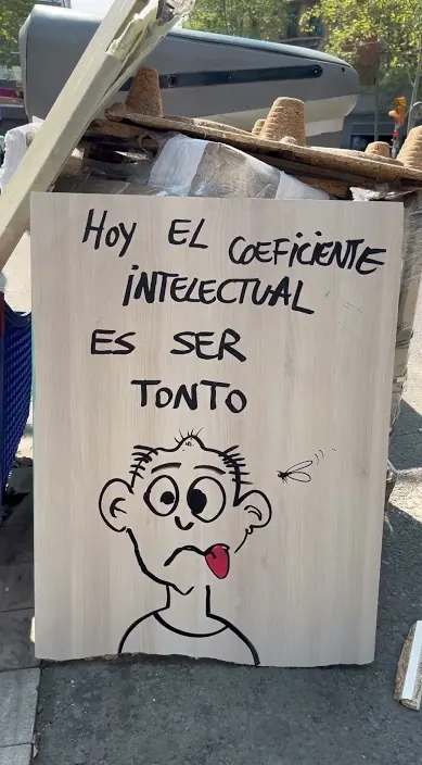 Painted board with a funny face and a line about the intelligence quotient, Barcelona, Art Is Trash