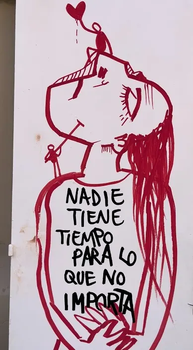 Red figure and a painted saying on a white board, Barcelona, Art Is Trash