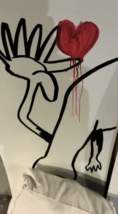 Figure drawn in black lines with a red heart, Barcelona, Art Is Trash