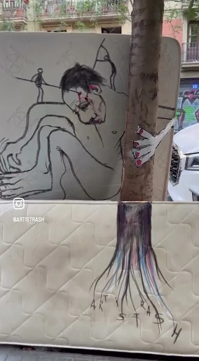 Old mattress with a painted figure leaning against a tree, Barcelona, Art Is Trash